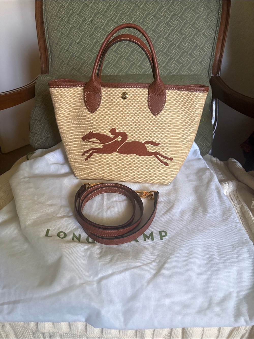 Longchamp straw tote with brown leather trim and horse motif